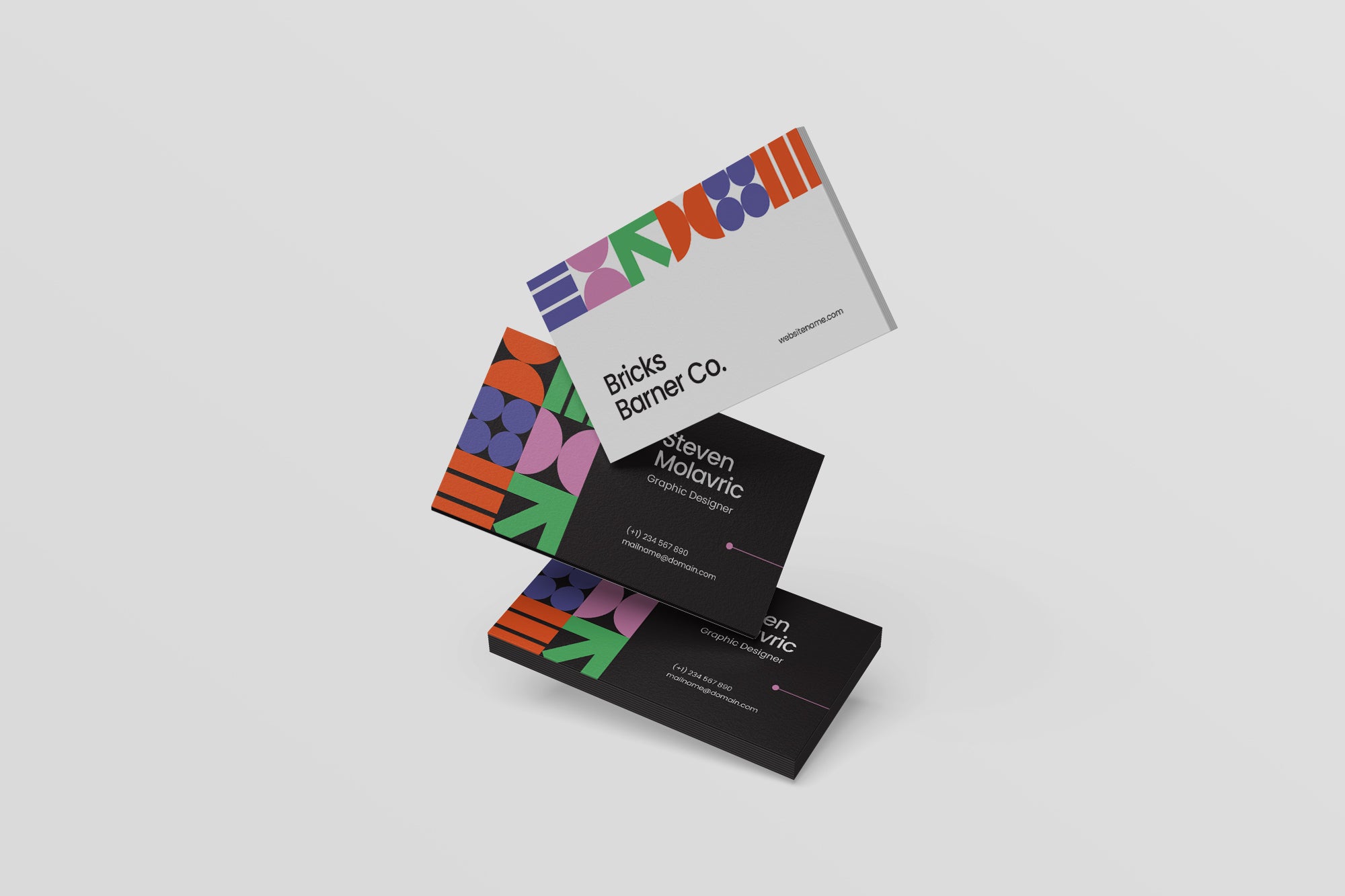 Colorful business cards with geometric designs on a light gray background