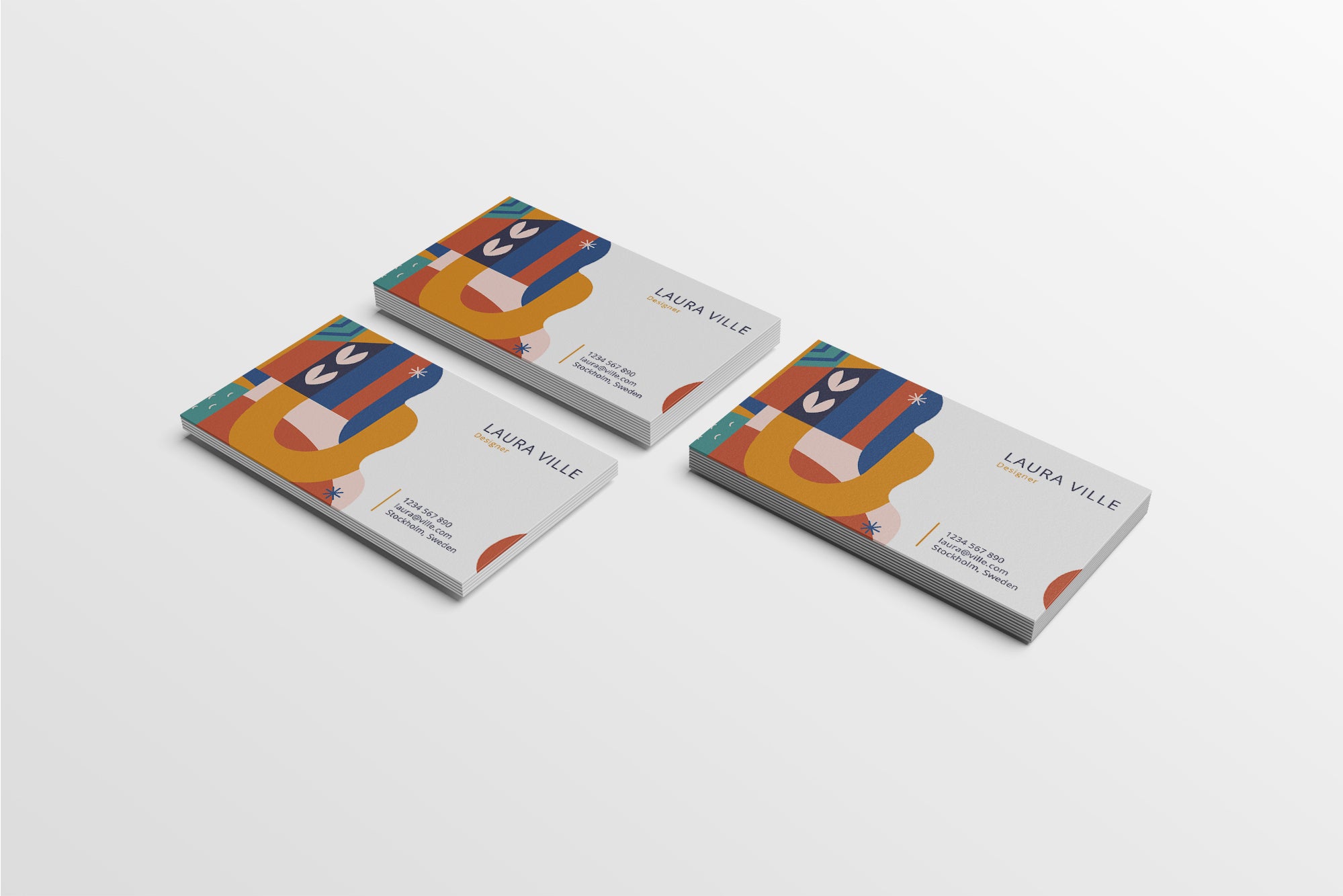 Four business cards with colorful designs on a white background