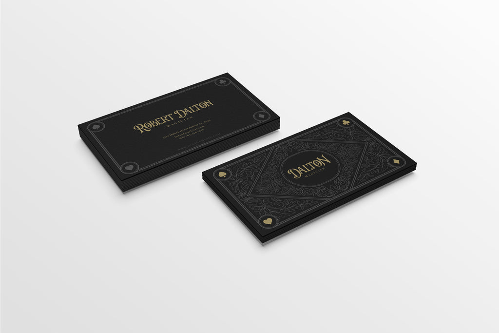 Two black leather-bound books with gold embossed text on a white background